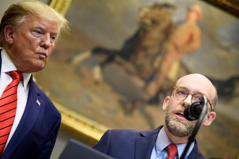 President Donald Trump listens while acting OMB Director Russell Vought speaks during an executive order signing regarding federal regulations in the Roosevelt Room of the White House October 9, 2019, in Washington, D.C.