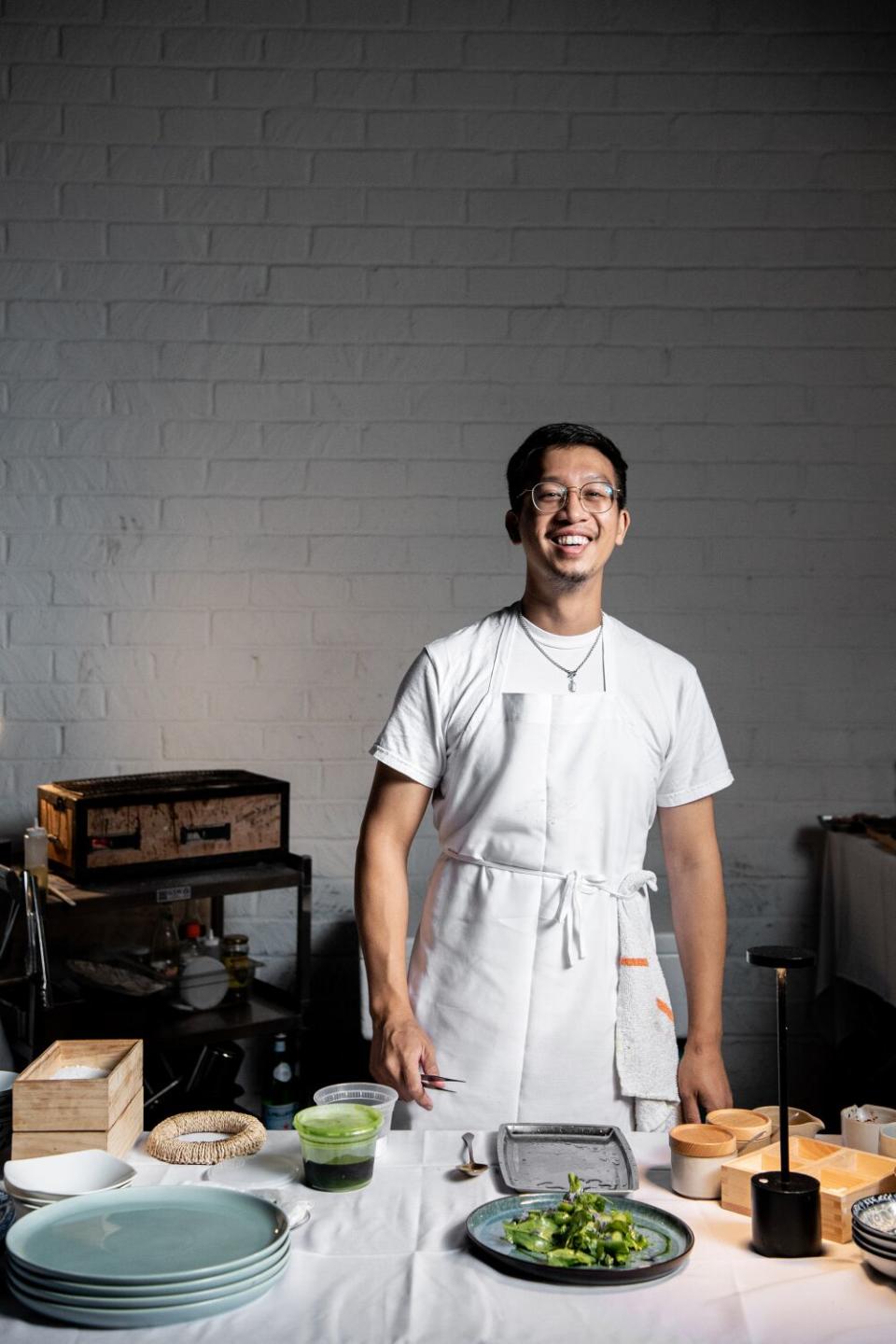 Anajak Thai chef and co-owner Justin Pichetrungsi poses in the kitchen.