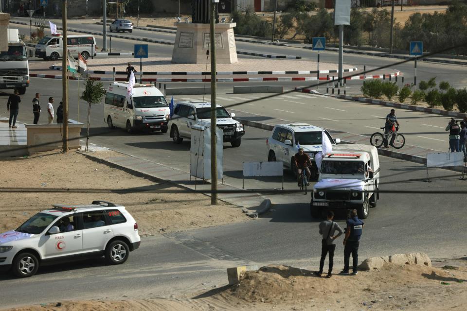 United Nations vehicles wait on the Palestinian side of the Gaza border at Rafah to collect humanitarian aid (AFP via Getty Images)