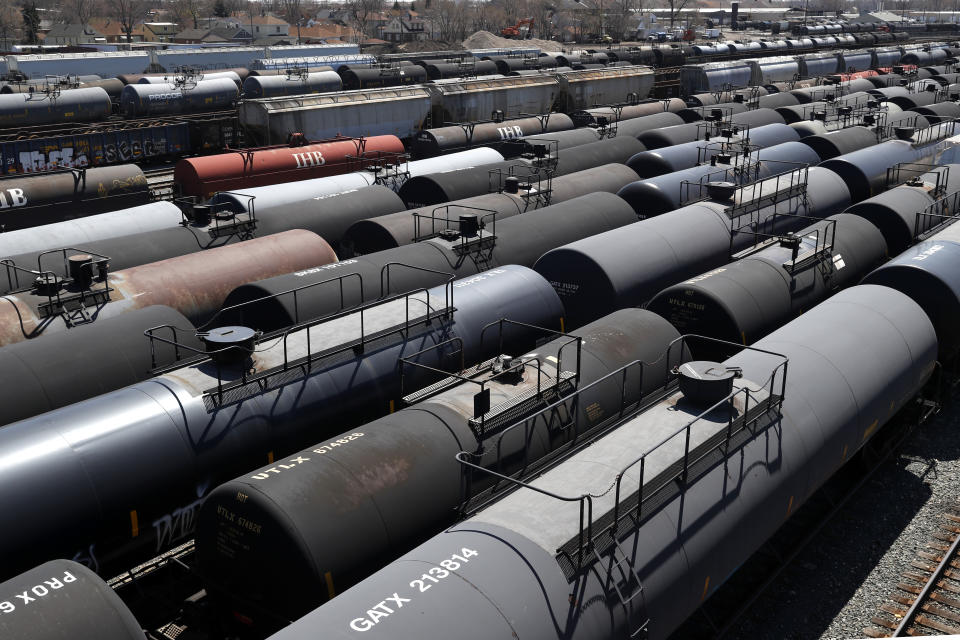 Oil tank train cars sit idle Tuesday, April 21, 2020, in East Chicago, Ind. The world is awash in oil, there's little demand for it and we're running out of places to put it. That in a nutshell explains this week's strange and unprecedented action in the market for crude oil futures contracts, where traders essentially offered to pay someone else to deal with the oil they were due to have delivered next month. (AP Photo/Charles Rex Arbogast)