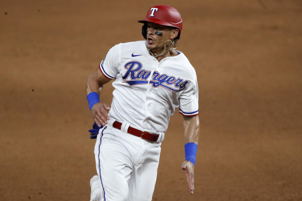 Texas Rangers Derek Dietrich advances to third on a double by Elvis Andrus during the eighth inning of the team's baseball game against the Seattle Mariners in Arlington, Texas, Wednesday, Aug. 12, 2020. (AP Photo/Tony Gutierrez)