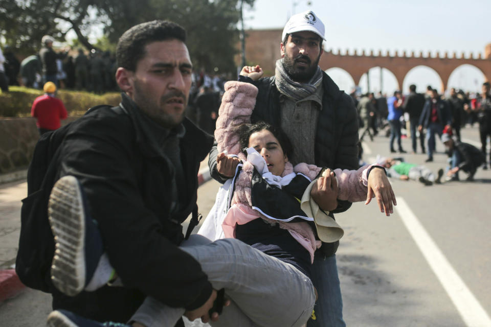 An injured protester is carried away after security forces dispersed a demonstration of teachers in Rabat, Morocco, Wednesday, Feb. 20, 2019. Moroccan police fired water cannons at protesting teachers who were marching toward a royal palace and beat people with truncheons amid demonstrations around the capital Wednesday. (AP Photo/Mosa'ab Elshamy)