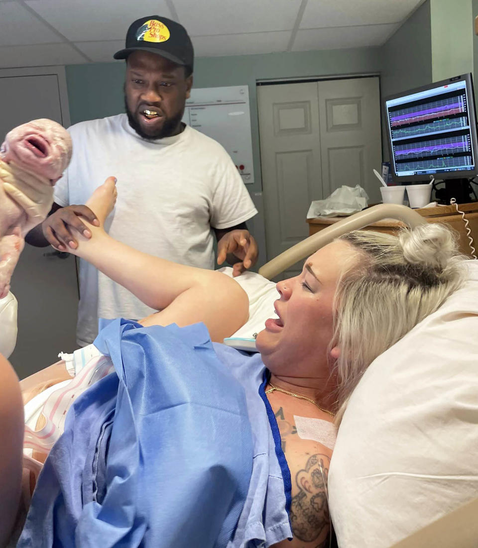 THAT'S how babies get born? Dad is shocked when he sees the business end of birth with baby No. 4. (Courtesy Amanda Roelofs)