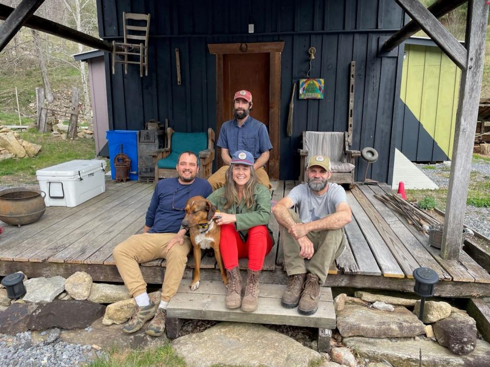 From left, Rare Bird Farm owners Mitchell Davis, Farrah Hoffmire, Edwin Self and Benjamin Gibbins pose in front of The Tom Hare Bunkhouse.