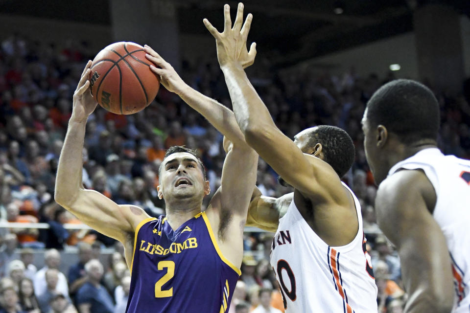 Auburn center Austin Wiley (50) defends against a shot by Lipscomb guard Andrew Fleming (2) during the first half of an NCAA college basketball game Sunday, Dec. 29, 2019, in Auburn, Ala. (AP Photo/Julie Bennett)