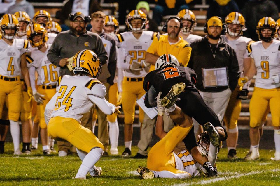 Newcomerstown's Bunk Millender is brought down on a run by West Jefferson's Luke Taylor as Wyatt Keyt looks on  during their Division 6 playoff game, Friday, Oct. 28 in Newcomerstown.