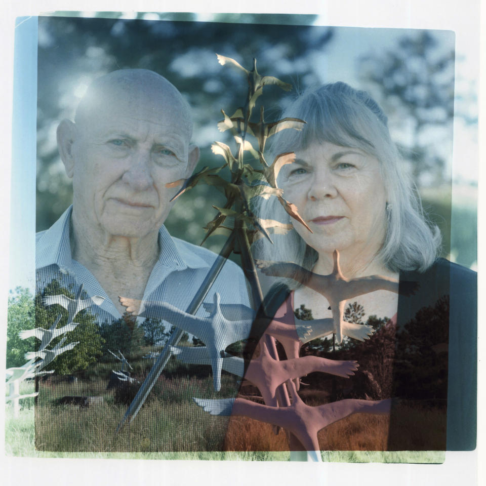 In this double exposure darkroom print made from two film negatives, a portrait of Lonnie, left, and Sandy Phillips from Tuesday, Sept. 5, 2023, is layered with a photo of the memorial to the victims of the 2012 mass shooting at a movie theater in which Jessica Ghawi, Sandy's daughter and Lonnie's stepdaughter, was killed in Aurora, Colo. Suffering through their own personal loss after the mass shooting, the couple set out to help other parents like them, traveling to shooting sites around the country. The trip continued for a decade. They'd found themselves in Newtown or Parkland or Uvalde or whatever fresh hell had just been put on the map. They had lessons to share, advice that could only be amassed by someone who'd lived through the same. So, Sandy would clasp the hands of the mourners and ask about the ones they'd been robbed of and mouth words that could surprise her as much as those who listened. "You will," she said confidently, "find joy again." Sometimes, Jessi visits her mother in her dreams, usually appearing as a toddler. When she awakes, she'll squeeze her eyes closed and try and coax the dream to return. She begs for more. "Let me feel her touch me," she says. "Let me feel her hug me. Let me feel her kiss me on the cheek again. Let me hear her laugh again. Let me hear her high heels coming up the walkway." Let me, she wishes, be happy. (AP Photo/David Goldman)