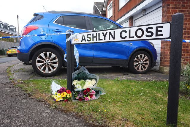 <p>James Manning/PA Images via Getty</p> Flowers have been laid on the street of the home