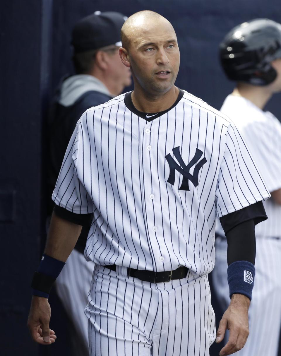 New York Yankees shortstop Derek Jeter walks in the dugout during the fourth inning of an exhibition baseball game against the Pittsburgh Pirates Thursday, Feb. 27, 2014, in Tampa, Fla. (AP Photo/Charlie Neibergall)