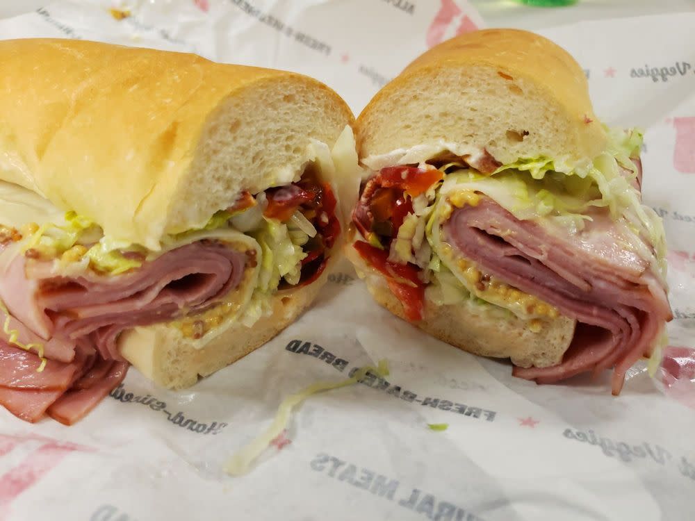 Jimmy John’s sub cut in the middle showing fillings of sliced meat and veggies