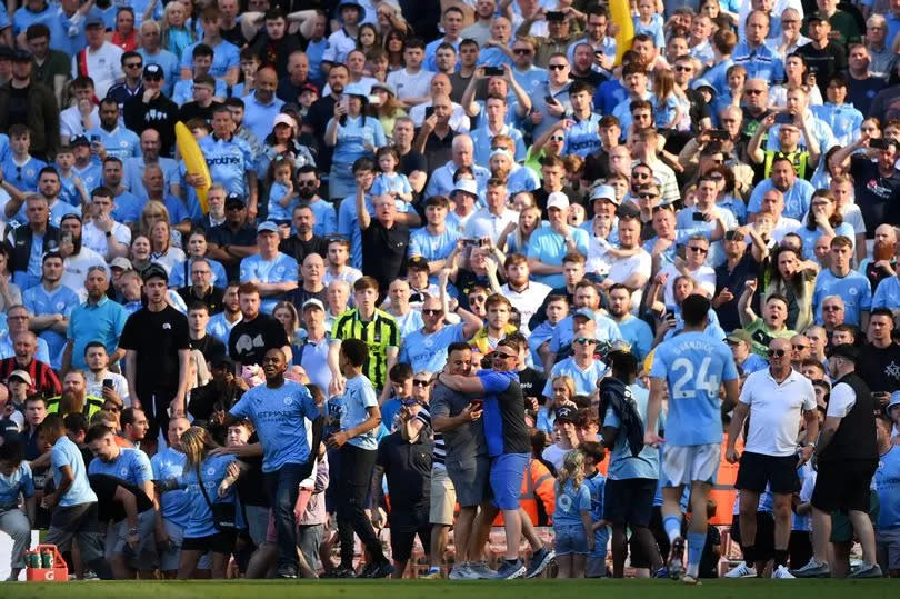 Manchester City fans encroach on the pitch before the end of the Premier League clash with West Ham