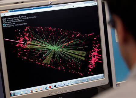 FILE PHOTO: A technician looks at collision at the CMS experiment in the control room of the Large Hadron Collider (LHC) at the European Organisation for Nuclear Research (CERN) near Geneva April 5, 2012. REUTERS/Denis Balibouse