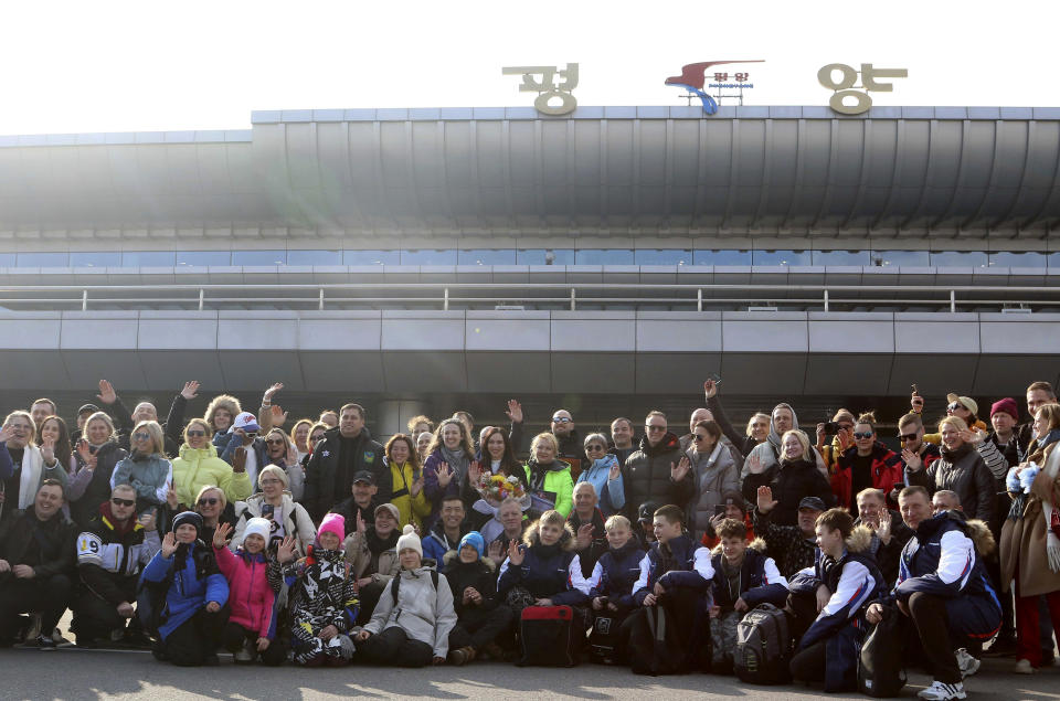 A group of Russian tourists, likely the first foreign travelers from any country to enter North Korea since the pandemic pose for a group photo on the arrival at the Pyongyang International Airport in Pyongyang, North Korea, Friday, Feb. 9, 2024. (AP Photo/Cha Song Ho)