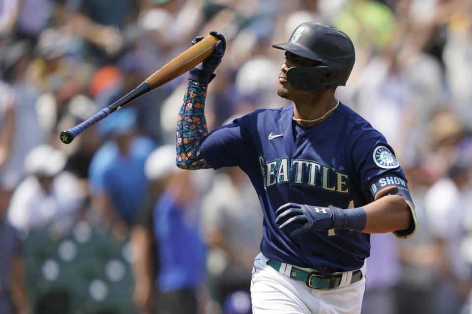 Seattle Mariners' Julio Rodriguez tosses his bat after hitting a three-run home run against the Texas Rangers during the seventh inning of a baseball game, Wednesday, July 27, 2022, in Seattle. (AP Photo/Ted S. Warren)