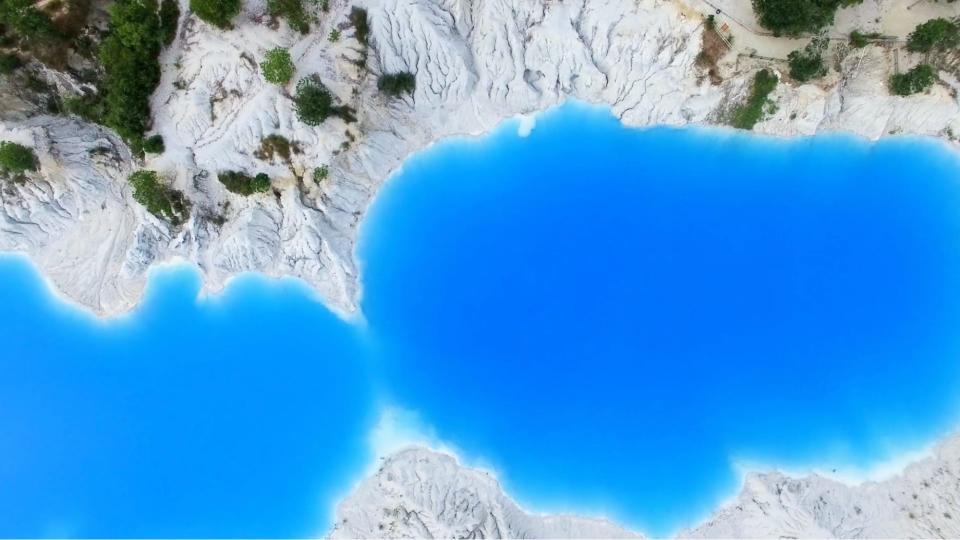 Overhead shot of Bangka and Belitung's toxic blue lakes.