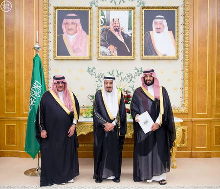 (L-R) Saudi Crown Prince Mohammed bin Nayef, Saudi King Salman, and Saudi Arabia's Deputy Crown Prince Mohammed bin Salman stand together after Saudi Arabia's cabinet agreed to implement a broad reform plan known as Vision 2030 in Riyadh, April 25, 2016. REUTERS/Saudi Press Agency/Handout via Reuters