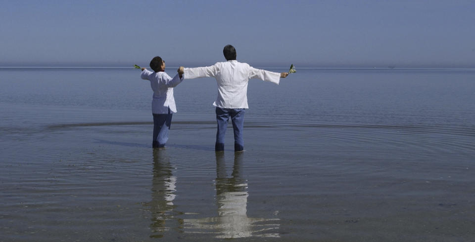 FILE - This photo by Associated Press photographer Elise Amendola shows Kathleen Clementson, 62, left, and Suzanne Nightingale, 49, of Cape Coral, Fla., sharing a private moment after they were pronounced as married at their wedding ceremony on Saint's Landing Beach in Brewster, Mass. Thursday, May 20, 2004, during the first week of state-sanctioned gay marriage in America. Amendola, who recently retired from the AP, died Thursday, May 11, 2023, at her home in North Andover, Mass., after a 13-year battle with ovarian cancer She was 70. (AP Photo/Elise Amendola, File)