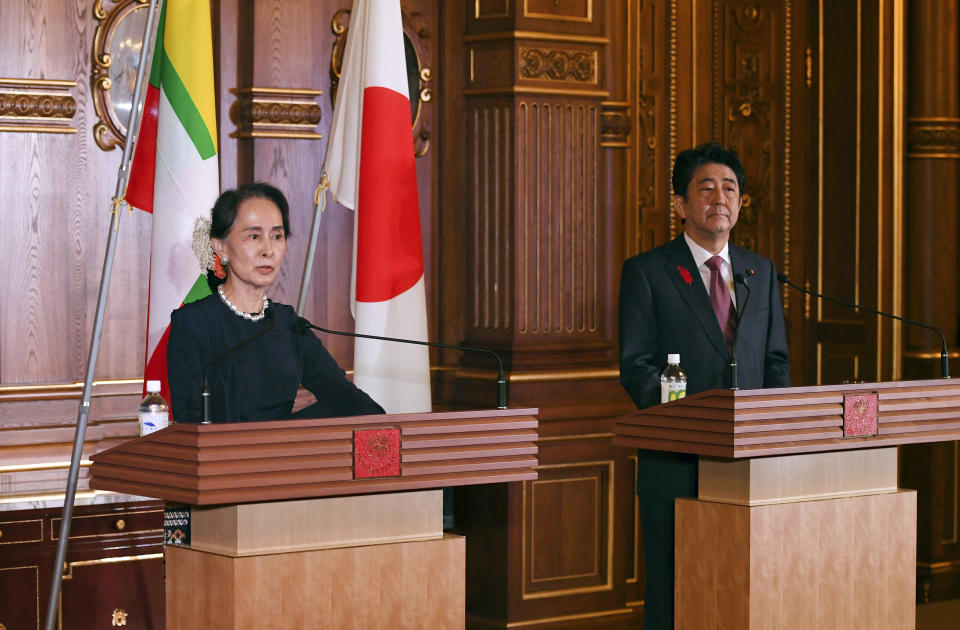 Myanmar's leader Aung San Suu Kyi delivers her speech beside Japanese Prime Minister Shinzo Abe during their joint press remarks following their bilateral meeting at the Akasaka Palace state guest house in Tokyo, Tuesday, Oct. 9, 2018. (Toshifumi Kitamura/Pool Photo via AP)