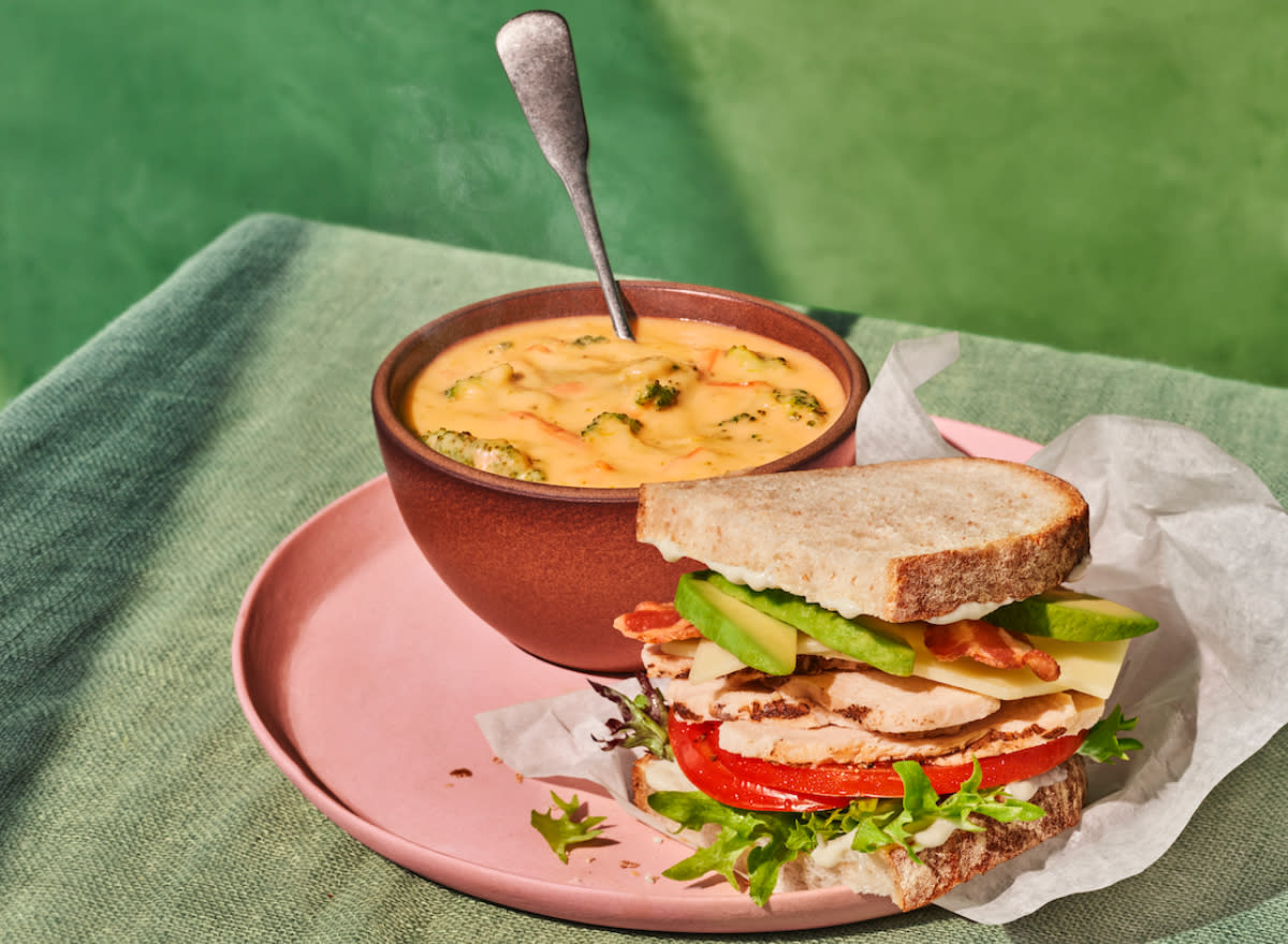 panera grilled chicken&avo melt half next to broccoli cheddar soup