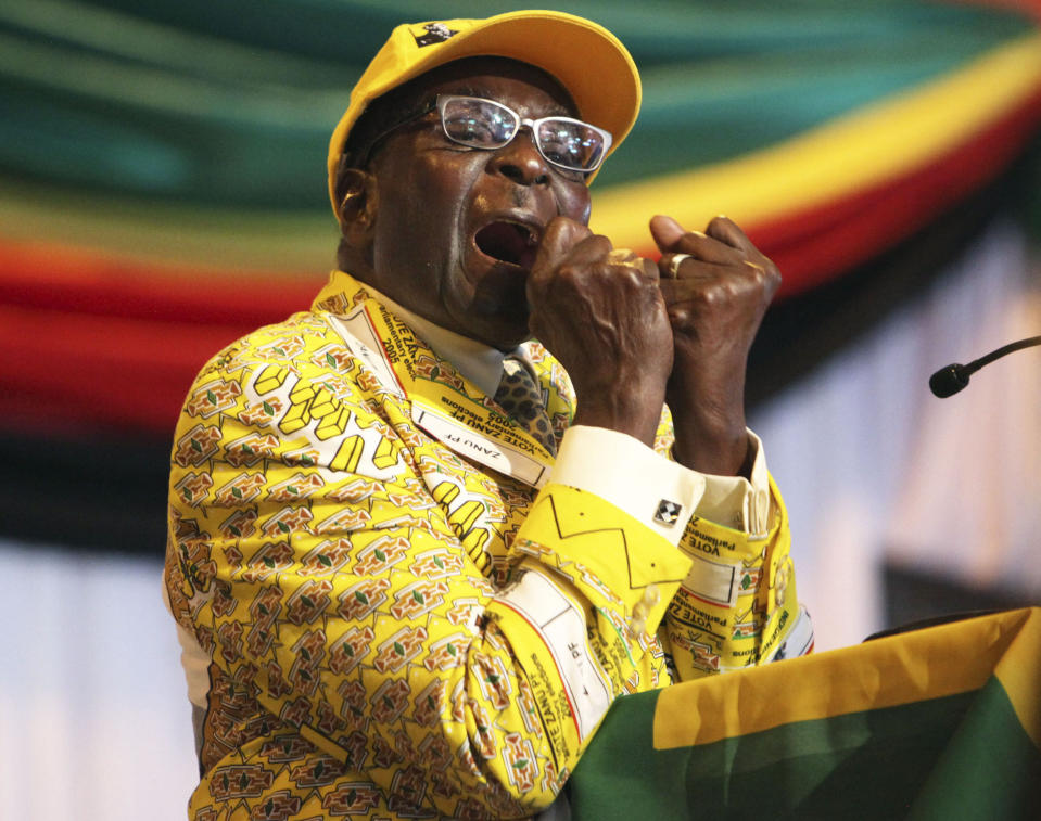 FILE - In this Friday, Dec. 7, 2012 file photo Zimbabwean President Robert Mugabe clenches his fists as he delivers his speech at his party's 13th annual conference, in Gweru about 250 Kilometres south west of the capital Harare. On Friday, Sept. 6, 2019, Zimbabwe President Emmerson Mnangagwa said his predecessor Mugabe, age 95, has died. (AP Photo/Tsvangirayi Mukwazhi, File)