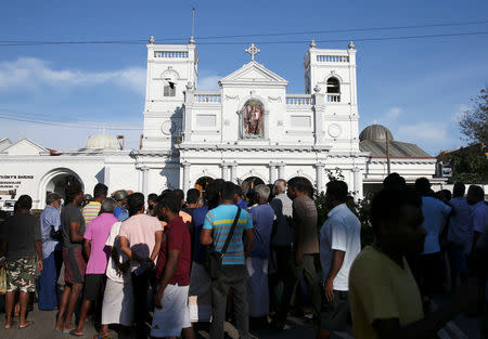 Locals stand in front of St Anthony's shrine in Colombo, after bomb blasts ripped through churches and luxury hotels on Easter, in Sri Lanka April 22, 2019. REUTERS/Athit Perawongmetha