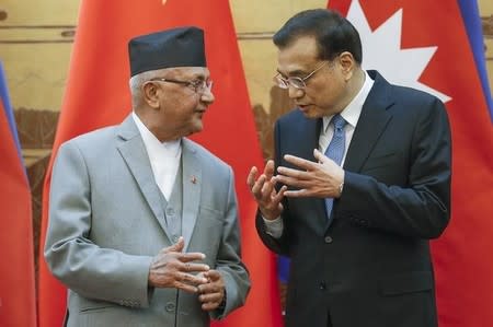 Chinese Premier Li Keqiang (R) talks to Nepal Prime Minister Khadga Prasad Sharma Oli during a signing ceremony at the Great Hall of the People in Beijing, China March 21, 2016. REUTERS/Lintao Zhang/Pool