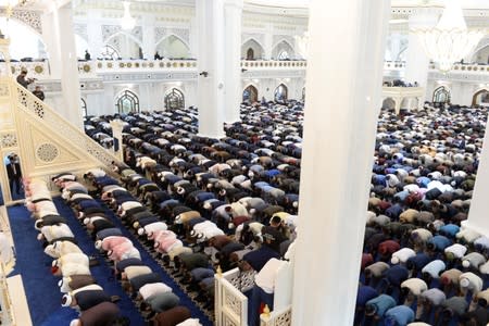 Muslims pray at a new mosque after an inauguration ceremony in Shali