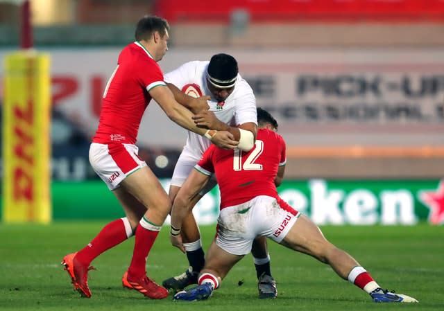 England’s Mako Vunipola is tackled by Dan Biggar, left, and Johnny Williams