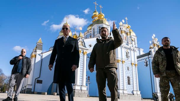 PHOTO: US President Joe Biden (C-L) walks with Ukrainian President Volodymyr Zelensky (C-R) at St. Michael's Golden-Domed Cathedral, Feb. 20, 2023, in Kyiv, Ukraine. (Evan Vucci/POOL/AFP via Getty Images)