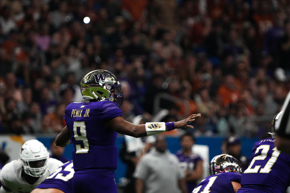 Washington Huskies quarterback Michael Penix Jr. (9) lines up the offense for a snap against Texas during the Alamo Bowl at the Alamodome, Thursday, Dec. 29, 2022 in San Antonio.