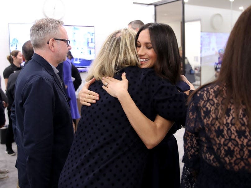 Meghan Markle hugs a woman at an event in 2018