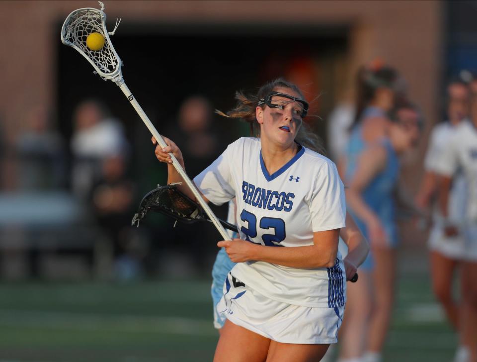 Bronxville's Catherine Berkery (22) works the ball behind the goal diring their 16-7 win over Suffern in girls lacrosse action at Haindl Field in Eastchester on Friday, April 22, 2022.