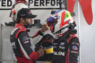 Felipe Nasr, left, and Pipo Derani, both from Brazil, talk in their pit stall during a practice session for the Rolex 24 hour race at Daytona International Speedway, Friday, Jan. 29, 2021, in Daytona Beach, Fla. (AP Photo/John Raoux)