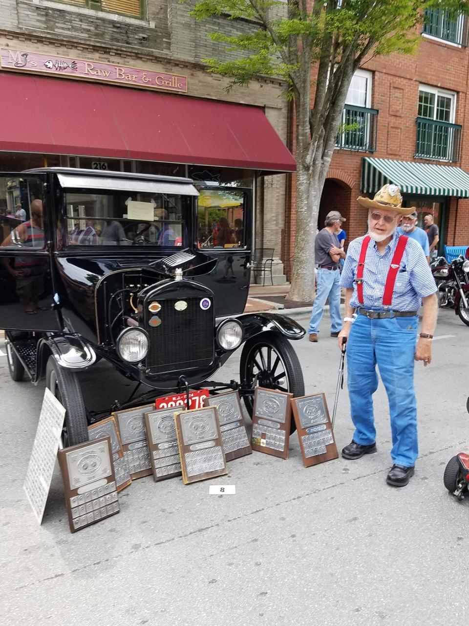 Marshall Van Winkle stands beside his multiple--award-winning Model T at a past New Bern car show.
