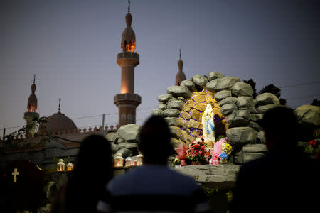 Expat worshippers pray in front of St. Mary's shrine at St. Mary's Catholic Church in Oud Metha, as Catholics are awaiting a historical visit by Pope Francis to the United Arab Emirates, in Dubai, UAE January 18, 2019. REUTERS/Ahmed Jadallah