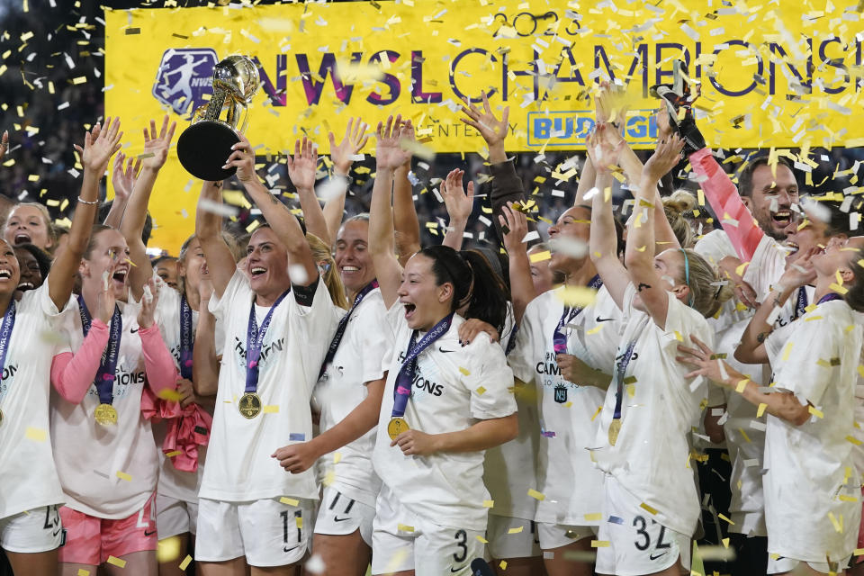 NJ/NY Gotham defender Ali Krieger holds the trophy after NJ/NY Gotham defeated OL Reign 2-1 in the NWSL Championship soccer game, Saturday, Nov. 11, 2023, in San Diego. (AP Photo/Gregory Bull)