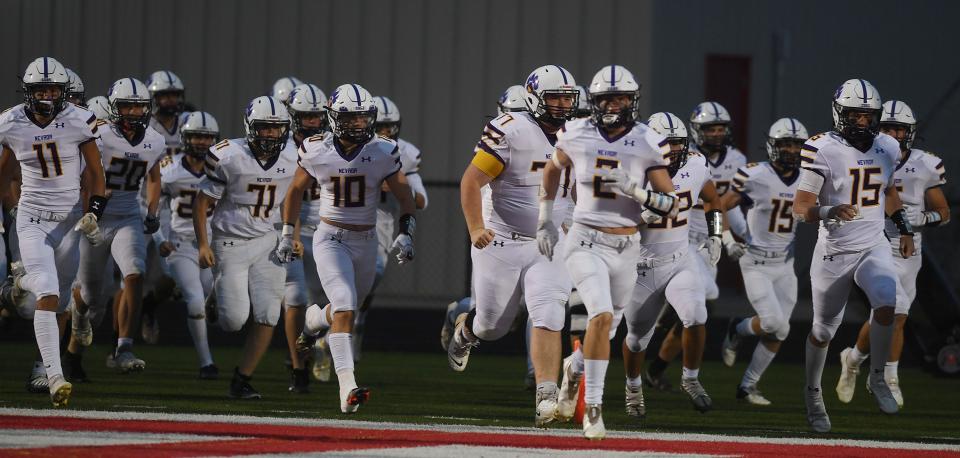 Nevada football players take the field before Friday's game at Gilbert.