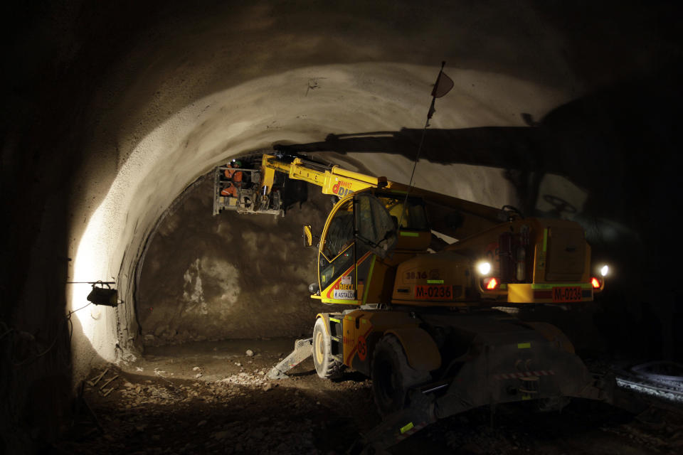 In this Sept. 25, 2012 photo, workers build a steel frame inside a drilled tunnel under the Chuquicamata copper mine in the Atacama desert in northern Chile. Experts say that by 2019 the Chuquicamata copper mine will be unprofitable, so state-owned mining company Codelco is trying to head off closure by converting the open pit into the world's largest underground mine. Codelco believes the mine still has much more to give, with reserves equal to about 60 percent of all the copper exploited in the mine's history still buried deep beneath the crater. (AP Photo/Jorge Saenz)