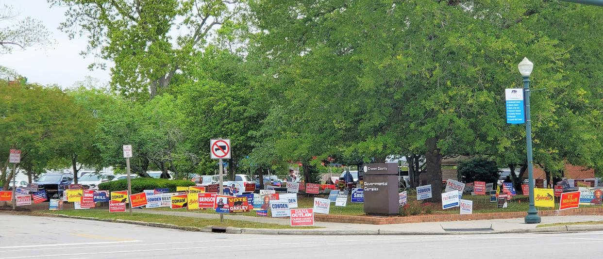 Candidates and campaigners gather outside the Craven County Board of Elections during early voting.