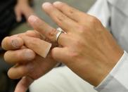 A 53-year-old former yakuza gangster shows off his silicone-made finger on May 27, 2013 during a visit to prosthetics specialist Shintaro Hayashi's office in Tokyo