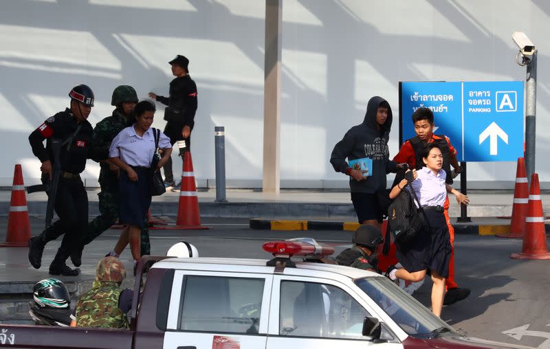 Thai security forces evacuate students stranded inside the Terminal 21 shopping mall following a gun battle to try to stop a soldier on a rampage after a mass shooting, Nakhon Ratchasima