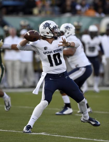 Oct 18, 2014; Fort Collins, CO, USA; Utah State Aggies quarterback Darell Garretson (10) looks to pass in the first quarter against the Colorado State Rams at Hughes Stadium. (Ron Chenoy-USA TODAY Sports)