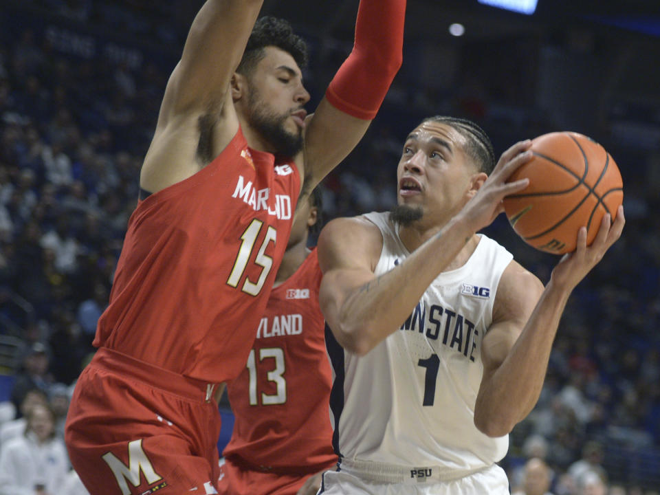 Penn State's Seth Lundy (1) goes to the basket on Maryland'sPatrick Emilien (15) during the first half of an NCAA college basketball game, Sunday, March 5, 2023, in State College, Pa. (AP Photo/Gary M. Baranec)