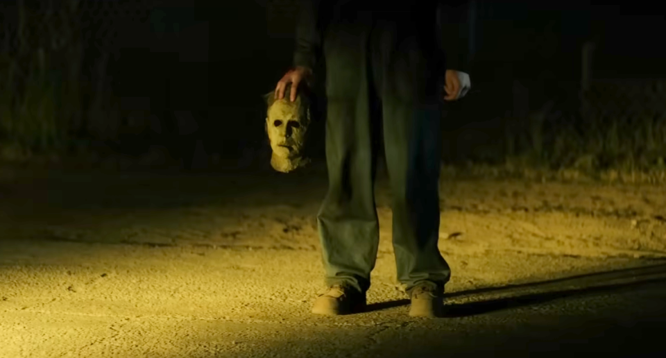 Someone holding Michael Myers' mask