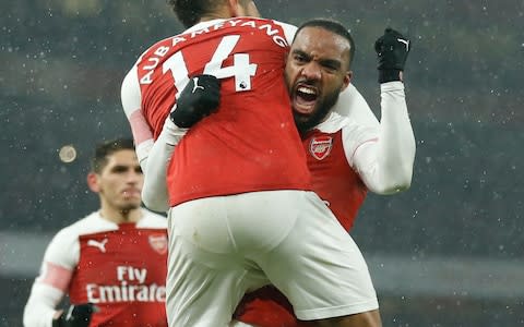 Arsenal's French striker Alexandre Lacazette (R) celebrates with team mates during the English Premier League football match between Arsenal and Cardiff City at the Emirates Stadium in London. - Credit: Getty images