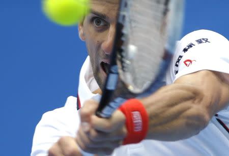 Novak Djokovic of Serbia returns the ball during his men's quarter-final match against Grigor Dimitrov of Bulgaria at the China Open tennis tournament in Beijing, October 3, 2014. REUTERS/Jason Lee