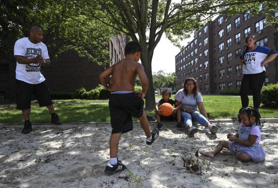 Lincoln and Heath (right) spend time with Lincoln’s daughter Janelle Hazard and her children at a playground in Hazard’s housing complex