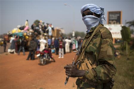 A Chadian soldier who is part of the African Union (AU) peacekeeping mission in the Central African Republic keeps guard during a repatriation exercise of people by road to Chad in the capital Bangui January 16, 2014. REUTERS/Siegfried Modola