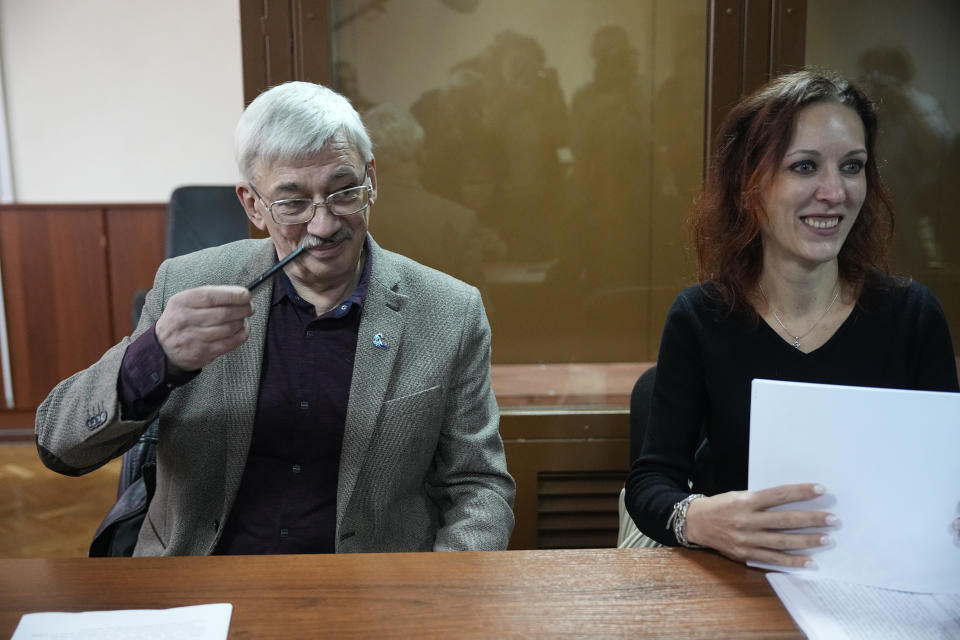 Oleg Orlov, a member of the Board of the International Historical Educational Charitable and Human Rights Society 'Memorial' (International Memorial), left, and his lawyer Yekaterina Tertukhina speak to journalists at a courtroom prior to a session in Moscow, Russia, Wednesday, Oct. 11, 2023. Orlov, the co-chair of the Nobel Peace Prize-winning human rights group Memorial, is on trial on charges of 