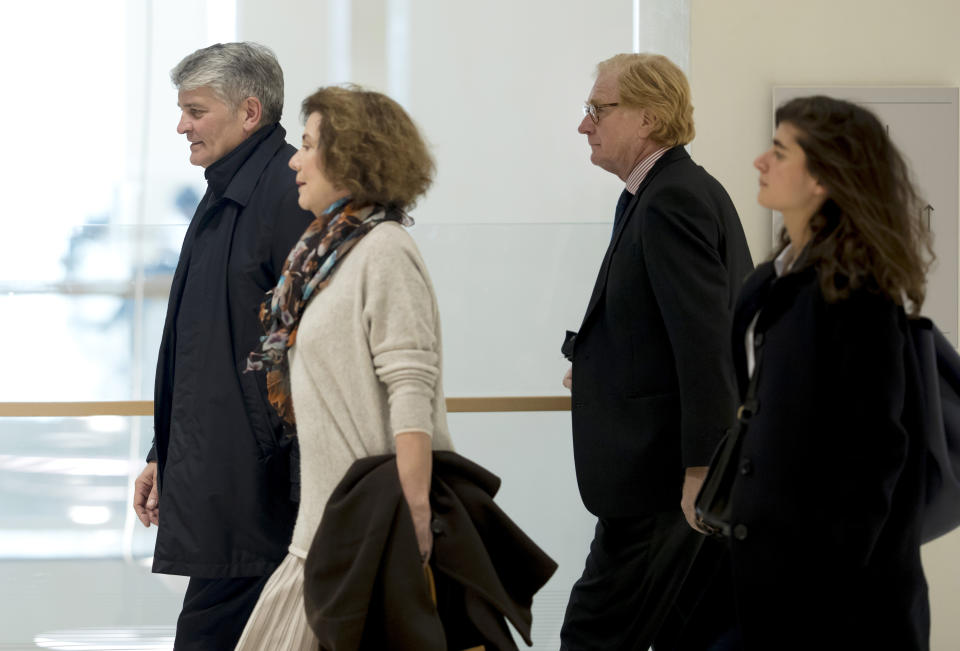 Former CEO of Global Wealth Management and Business Banking at UBS AG Raoul Weil, left, his wife, 2nd left, former General Director of UBS France Patrick de Fayet, 2nd right, and one member of their legal team arrive for the the Swiss bank's trial at the Paris courthouse in Paris, France, Wednesday, Feb. 20, 2019. A Paris court has ordered Swiss bank UBS to pay 3.7 billion euros ($4.2 billion) in fines for helping wealthy French clients evade tax authorities. (AP Photo/Michel Euler)